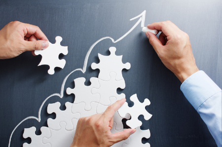 Maintaining performance improvement momentum represented by building upward trending puzzle. Credit: https://www.istockphoto.com/portfolio/tadamichi