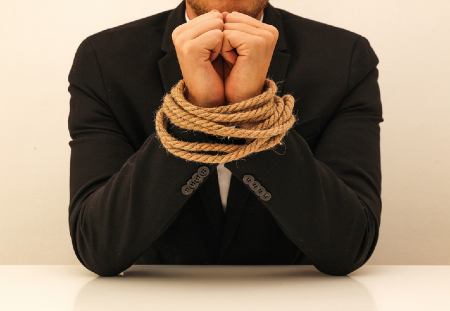 Business man with hands tied. Credit https://www.istockphoto.com/portfolio/studio4pic