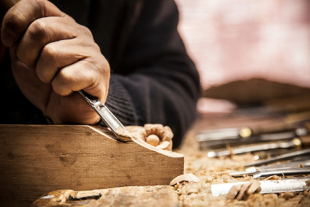 Image of a wood carver using a chisel. Credit: https://www.istockphoto.com/portfolio/PhotoShoppin