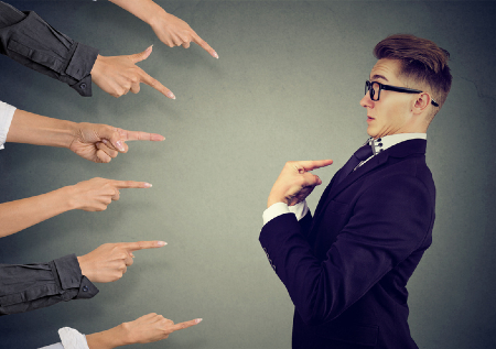 Fingers pointing at man holding him accountable. Credit: https://www.istockphoto.com/portfolio/siphotography