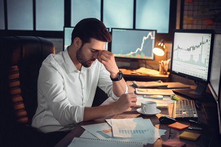 A frustrated male worker with eyes closed and his hand to his face. Credit: https://www.istockphoto.com/au/portfolio/VictoriaGnatiuk