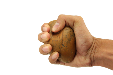 A hand holding a very tangible rock. Credit: https://www.istockphoto.com/au/portfolio/t-gomo