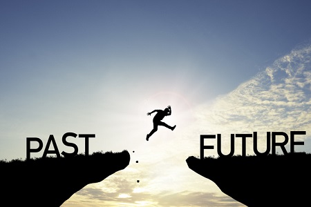 A man jumping over a gap from past to future. Credit: https://www.istockphoto.com/portfolio/DilokKlaisataporn