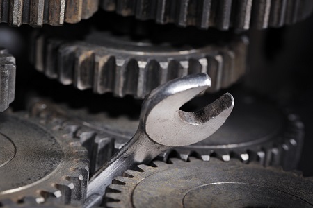 A spanner jamming up the gears in a machine. Credit: https://www.istockphoto.com/portfolio/stocksnapper